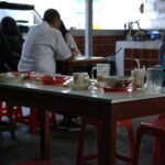 a group of people sitting at a table in a restaurant